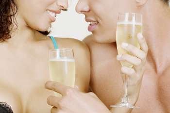 Mid section view of a man and woman holding champagne flutes