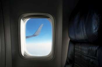 Airplane wing seen through an airplane window