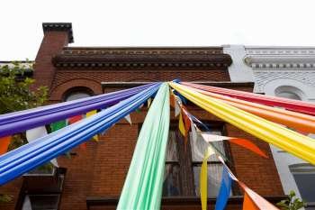 Low angle view of gay pride symbols tied up in front of a building, Dupont Circle, Washington Dc, USA