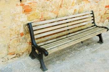 Empty bench in front of a wall, Monteriggioni, Siena Province, Tuscany, Italy