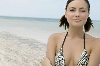 Portrait of a young woman smirking on the beach
