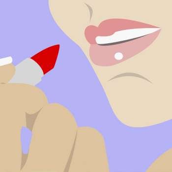 Close-up of a woman applying lipstick