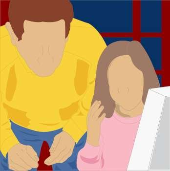 Close-up of a girl using a computer with her father standing behind her