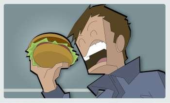 Low angle view of a boy eating a burger
