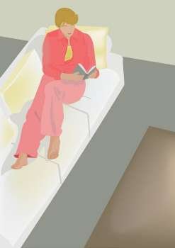 High angle view of a woman sitting on a couch reading a book