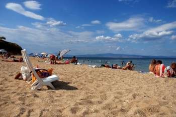sunbathers in Fokea beach, Greece