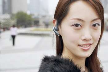 Portrait of a young woman wearing a hands free device