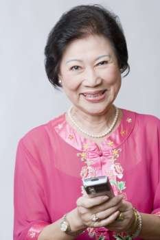 Portrait of a senior woman holding a mobile phone and smiling