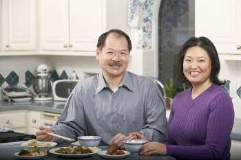 Portrait of a senior man smiling with a mature woman at the breakfast table