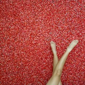 Low section view of a woman on rose petals