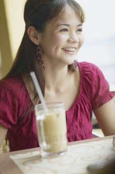 Close-up of a young woman sitting in a restaurant