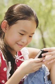 Close-up of a girl using a mobile phone