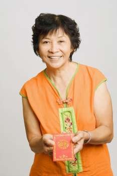 Portrait of a mature woman holding a greeting card
