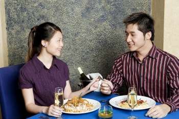 Young couple sitting at a table in a restaurant