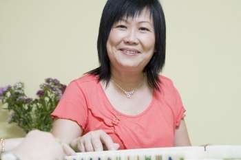 Portrait of a mature woman playing mahjong and smiling
