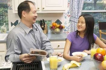 Close-up of a father and his daughter in the kitchen