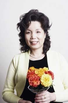 Portrait of a businesswoman holding a flower vase
