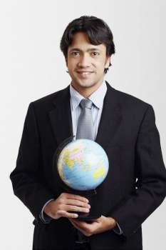 Portrait of a businessman holding a globe and smiling