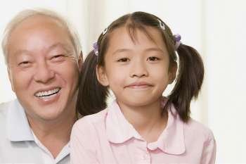 Portrait of a girl smiling with her grandfather