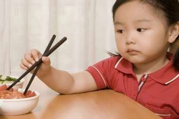 Close-up of a girl holding a chopsticks