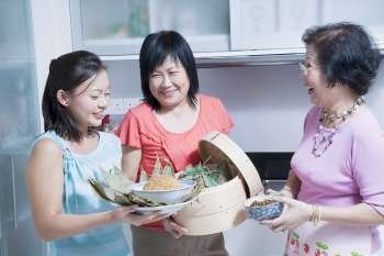 Senior woman with her daughter and granddaughter in a kitchen
