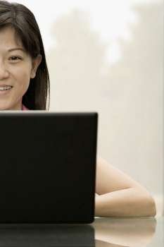 Portrait of a female office worker using a laptop