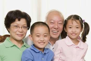Portrait of a mature couple smiling with their grandchildren
