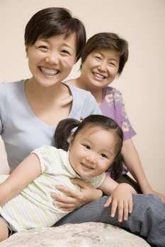 Portrait of a mature woman smiling with her daughter and granddaughter