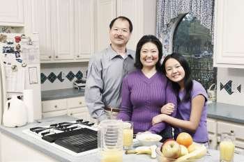 Portrait of a girl and her parents in the kitchen