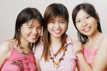 Portrait of three young women looking cheerful