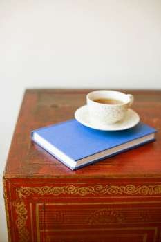 Close-up of a cup on a diary