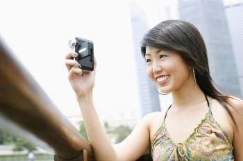 Close-up of a young woman using a video camera