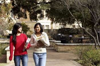 Two young women walking in a college campus