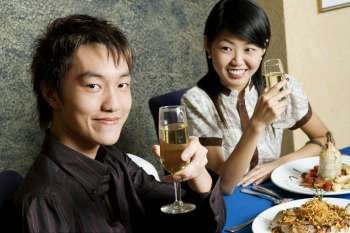Close-up of a young couple holding glasses of champagne