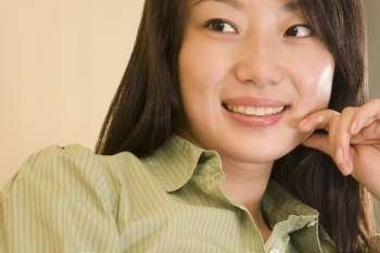 Close-up of a young woman smiling and looking sideways