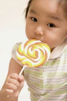 Portrait of a girl eating a lollipop