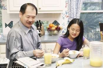 Close-up of a father and his daughter in the kitchen