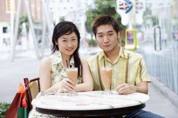 Portrait of a young couple sitting in a cafeteria