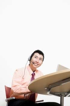 Businessman wearing headset and smiling