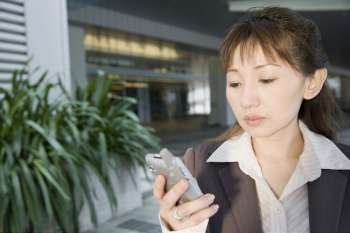Close-up of a businesswoman holding a mobile phone