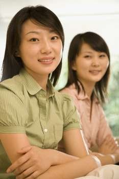 Portrait of two office workers smiling in an office