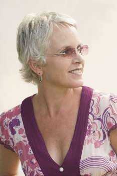 Close-up of a mature woman wearing sunglasses and smiling