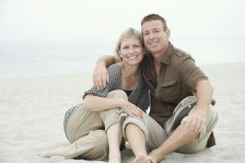 Portrait of a mature couple sitting on the beach