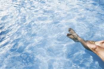 Low section view of a person in a swimming pool