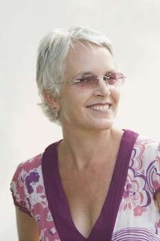 Close-up of a mature woman wearing sunglasses and smiling