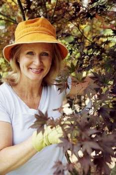 Portrait of a mature woman gardening and smiling