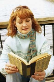 Close-up of a mature woman reading a book