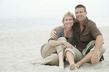 Portrait of a mature couple sitting on the beach