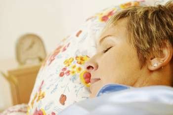 Close-up of a mature woman sleeping on the bed
