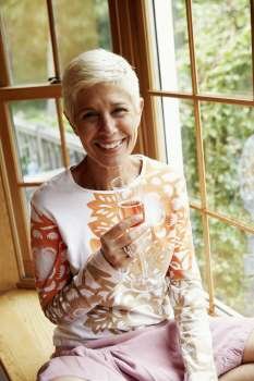 Portrait of a senior woman holding a champagne flute and smiling